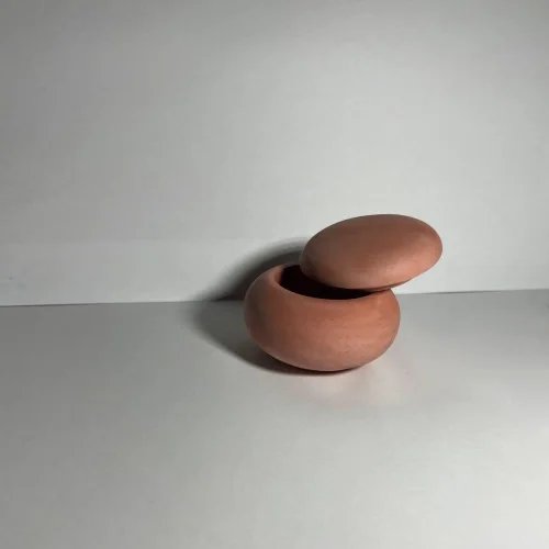 The "Stone" candle holder with a lid is red