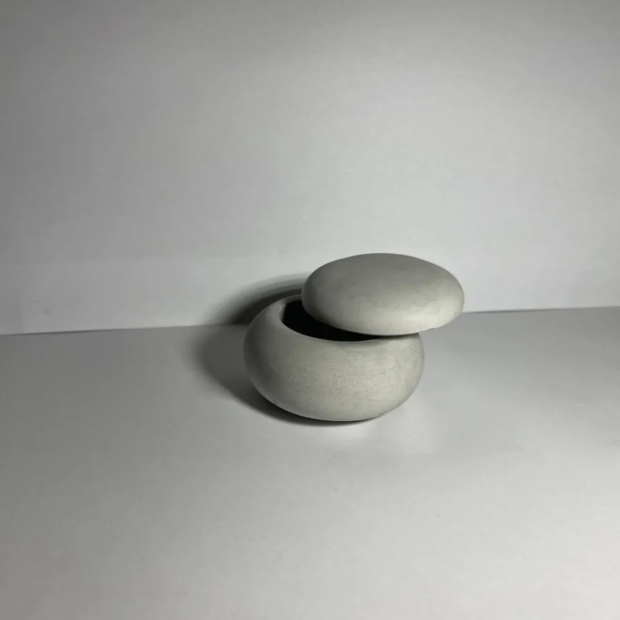 The "Stone" candle holder with a lid is gray