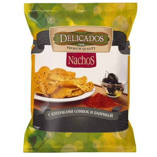 Nachos corn chips with olive slices and paprika